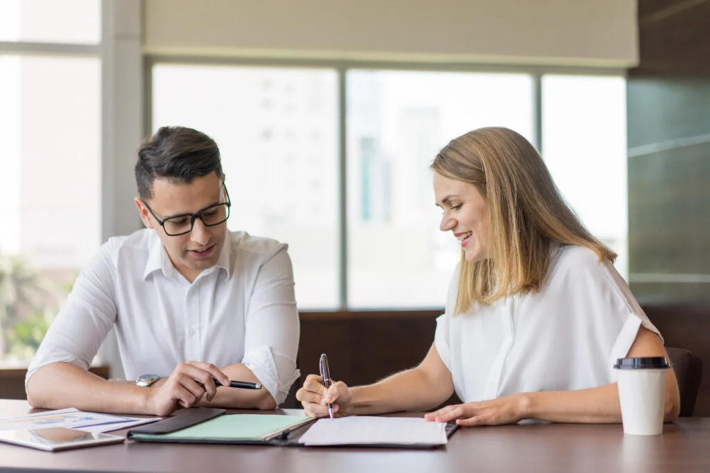 Colleagues working with documents in office