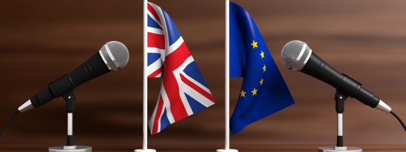 Relationship between European Union and England. Cable microphones on stands on a wooden background, banner. 3d illustration